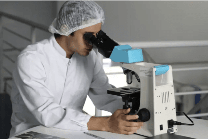 Clinician using microscope